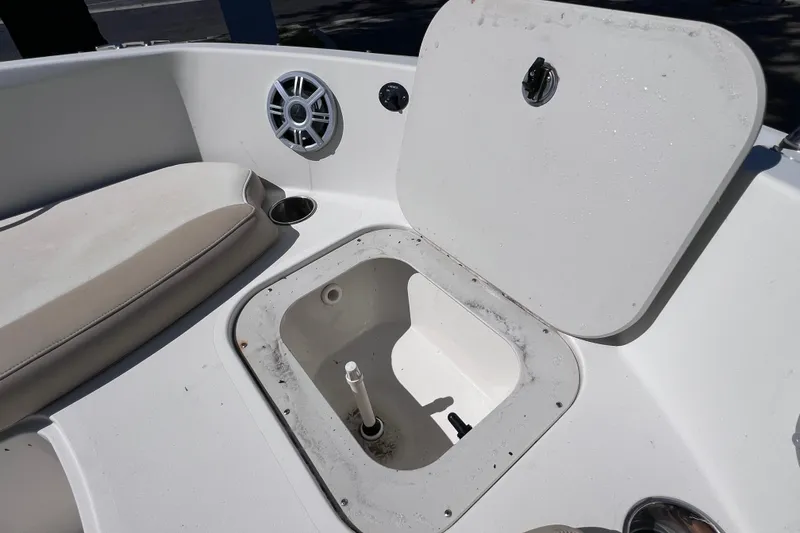 Slide: The Image of Open storage compartment on 2017 Stingray 182 SC boat deck with speaker and seating. - 21