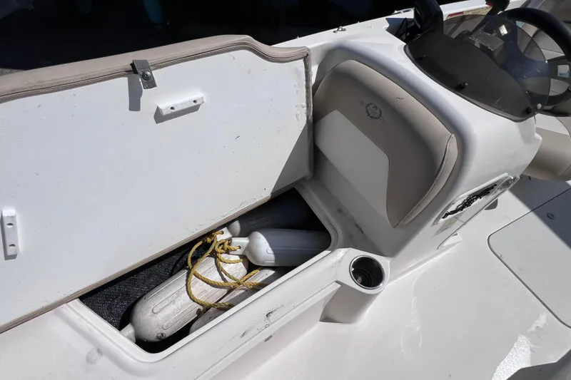Slide: The Image of 2017 Stingray 182 SC boat storage compartment with fenders and ropes. - 22