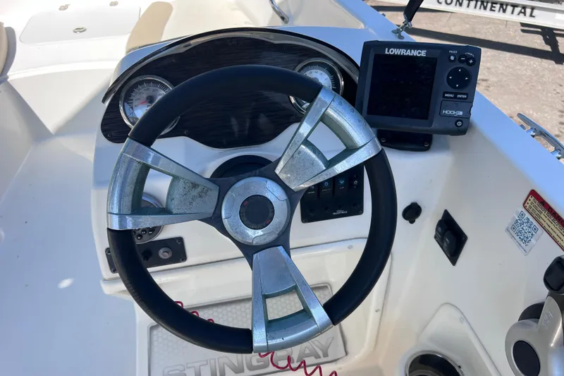 Slide: The Image of Steering wheel and dashboard of a 2017 Stingray 182 SC boat with Lowrance display. - 24