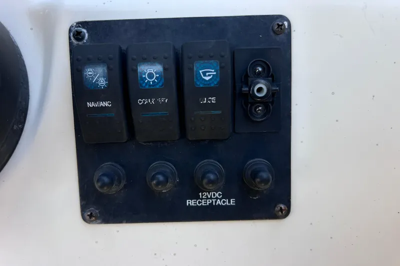 Slide: The Image of Control panel of a 2017 Stingray 182 SC boat with switches and 12VDC receptacle. - 28
