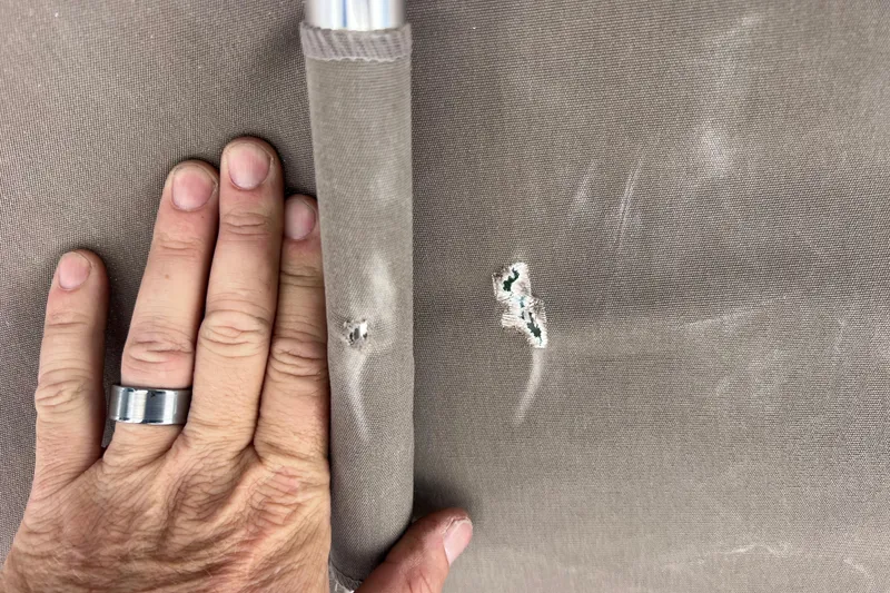 Slide: The Image of Hand inspecting fabric damage on 2017 Stingray 182 SC boat upholstery. - 32