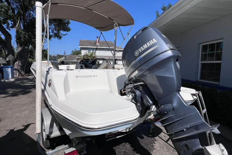 Slide: The Image of 2017 Stingray 182 SC boat with Yamaha outboard motor, parked outdoors. - 5