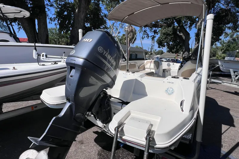 Slide: The Image of 2017 Stingray 182 SC boat with Yamaha 90 engine, parked outdoors. - 6