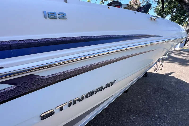 Slide: The Image of 2017 Stingray 182 SC boat side view with sleek design and branding. - 8