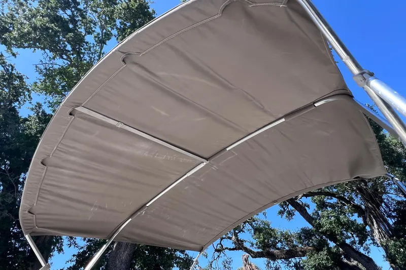 Slide: The Image of Bimini top of 2017 Stingray 182 SC boat against a clear blue sky. - 9