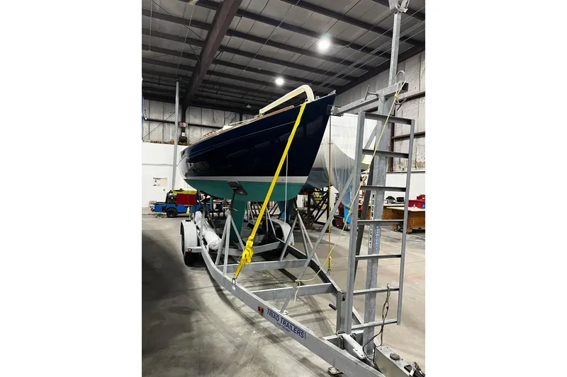 Slide: The Image of 2012 Alerion Express 28 sailboat on trailer in indoor storage facility. - 19