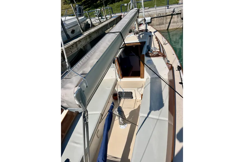Slide: The Image of 2012 Alerion Express 28 sailboat docked, showcasing deck and cockpit area. - 5