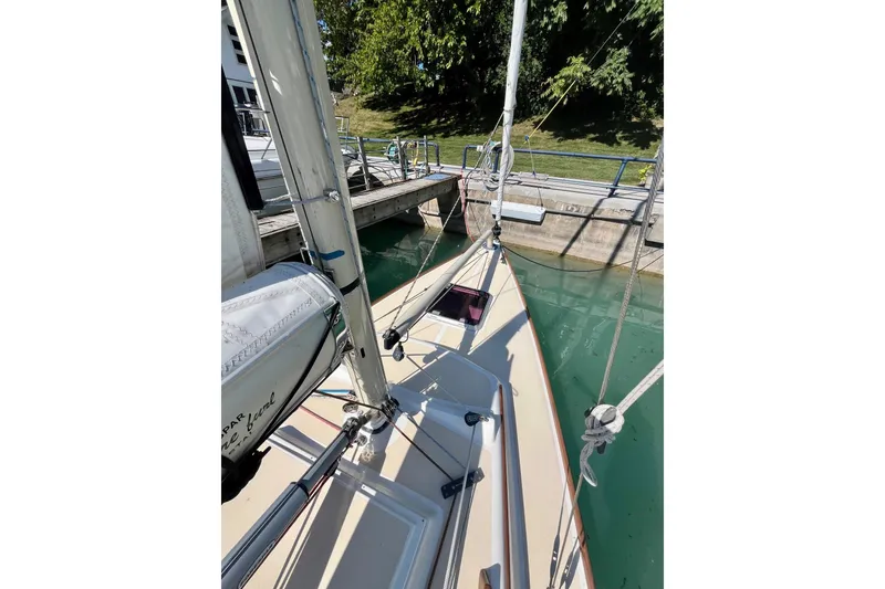Slide: The Image of 2012 Alerion Express 28 sailboat docked, showing deck and mast details. - 6