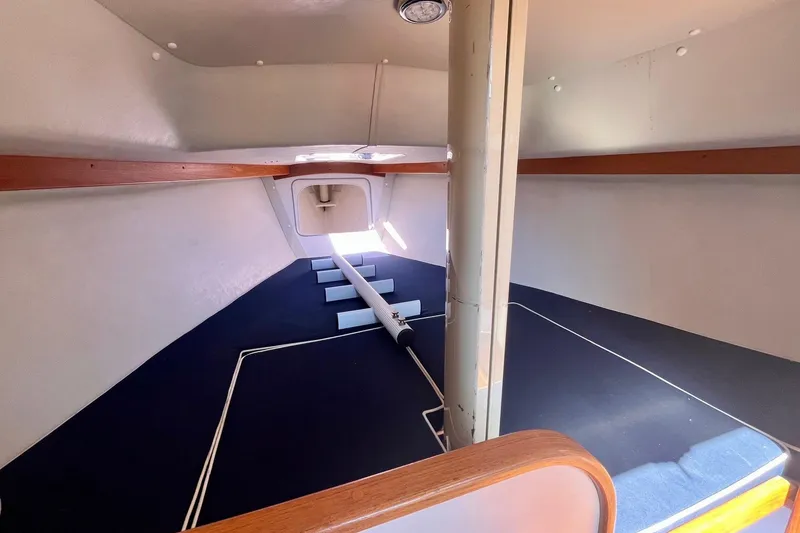 Slide: The Image of Interior cabin of 2012 Alerion Express 28 sailboat, featuring spacious layout and wooden accents. - 8