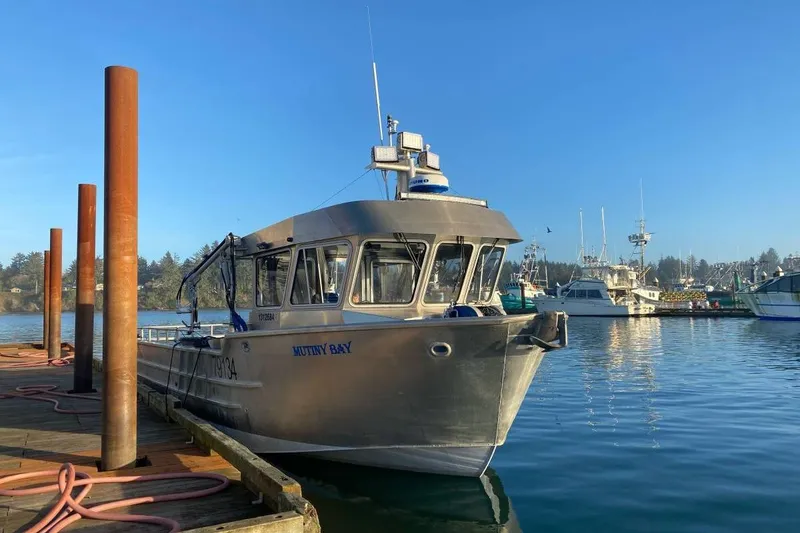 The Image of Custom 2021 Aluminum Crabber boat docked in a serene harbor under clear blue skies. - 0