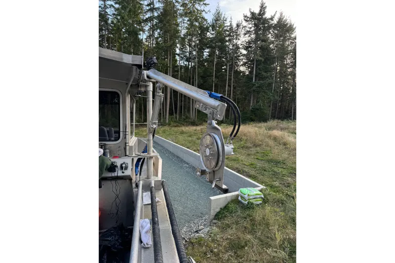 Slide: The Image of Custom 2021 Aluminum Crabber with hydraulic equipment, set against a forest backdrop. - 13