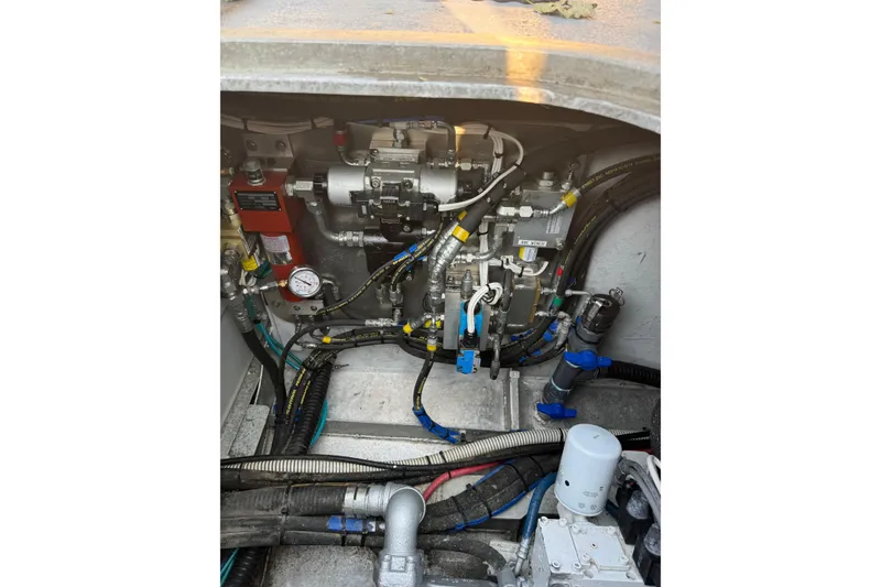Slide: The Image of Engine compartment of a 2021 Custom Aluminum Crabber boat, showcasing intricate machinery and wiring. - 14