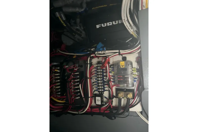 Slide: The Image of Electrical wiring and fuse panel inside a 2021 Custom Aluminum Crabber boat. - 15
