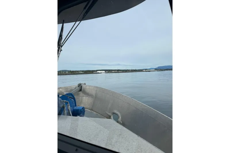 Slide: The Image of Custom 2021 Aluminum Crabber boat on calm waters with distant shoreline view. - 18