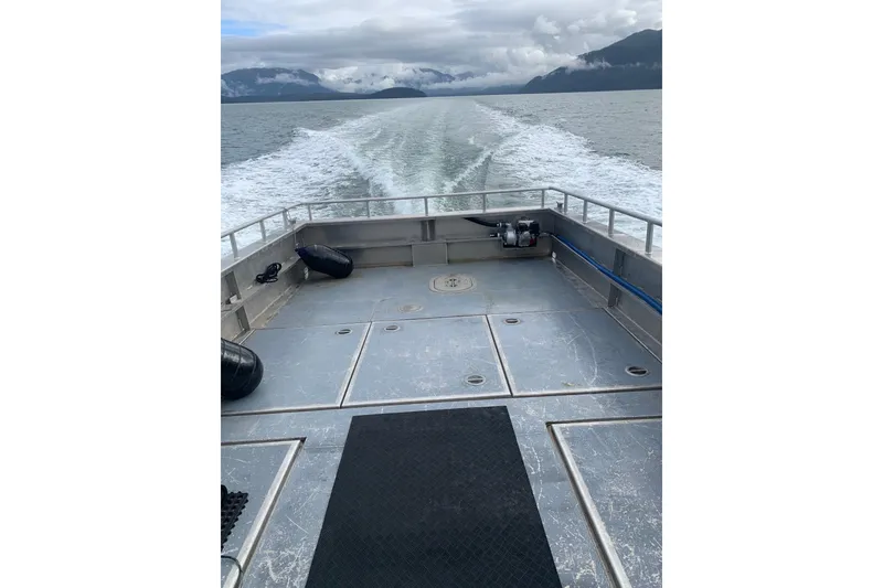 Slide: The Image of Custom 2021 Aluminum Crabber boat on open water, leaving a wake behind. - 19