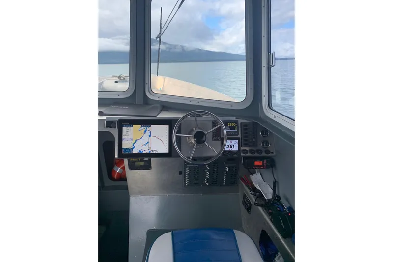 Slide: The Image of Interior view of 2021 Custom Aluminum Crabber boat cockpit with navigation equipment. - 2