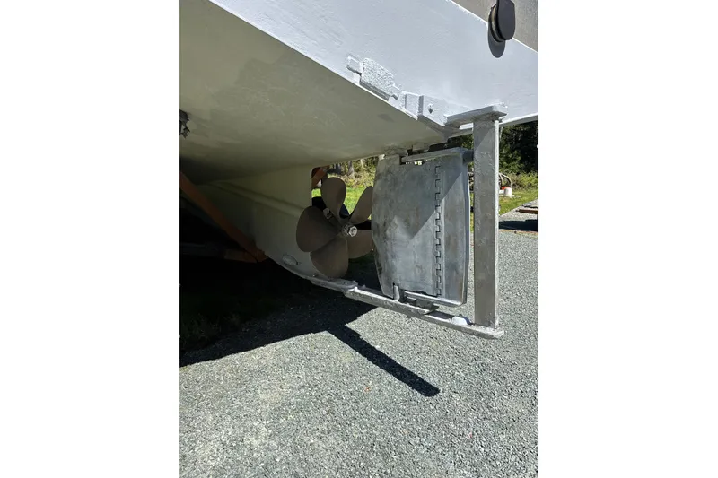 Slide: The Image of Custom 2021 Aluminum Crabber boat propeller and rudder on gravel surface. - 22
