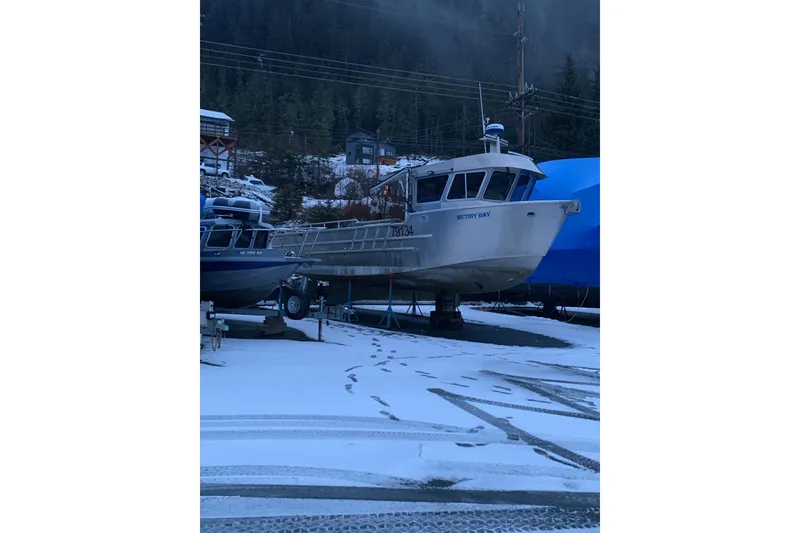 Slide: The Image of Custom 2021 Aluminum Crabber boat on snowy dock, surrounded by winter landscape. - 23