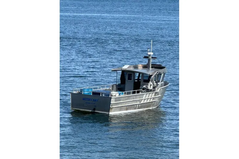 Slide: The Image of Custom 2021 Aluminum Crabber boat on calm blue water. - 26