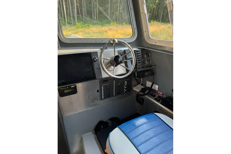 Slide: The Image of Interior of 2021 Custom Aluminum Crabber boat with steering wheel and control panel. - 3