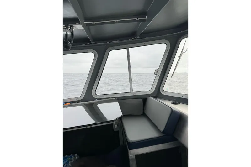 Slide: The Image of Interior view of 2021 Custom Aluminum Crabber boat with ocean through windows. - 4