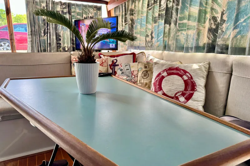 Slide: The Image of Interior of 1988 Bayliner 3218 Motoryacht with nautical-themed decor and potted plant. - 12