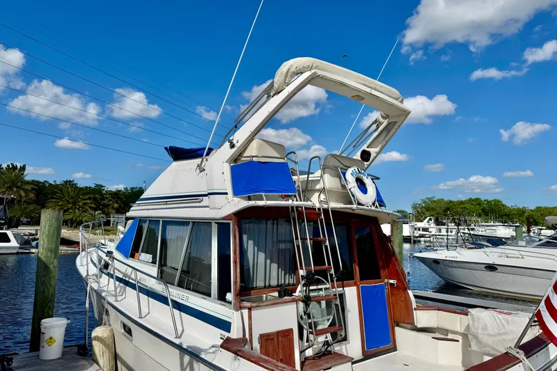 Slide: The Image of 1988 Bayliner 3218 Motoryacht docked at marina under clear blue sky. - 17