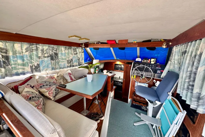 Slide: The Image of Interior of 1988 Bayliner 3218 Motoryacht with seating, table, and helm station. - 3