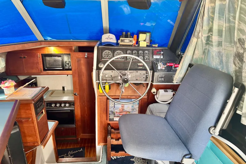 Slide: The Image of Interior of 1988 Bayliner 3218 Motoryacht with helm, kitchen, and seating area. - 5