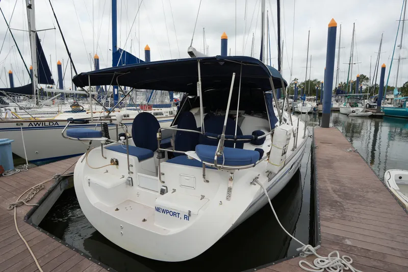 The Image of 2003 Catalina 400 MkII sailboat docked at marina with blue canopy and seating. - 1