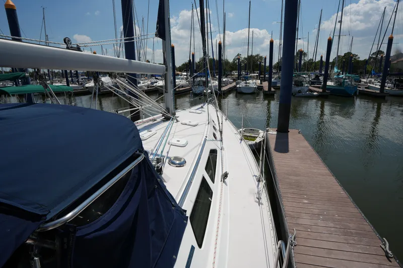 Slide: The Image of 2003 Catalina 400 MkII sailboat docked at a marina under a clear blue sky. - 10