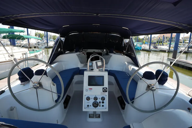 Slide: The Image of Cockpit of a 2003 Catalina 400 MkII sailboat with dual steering wheels in a marina. - 14