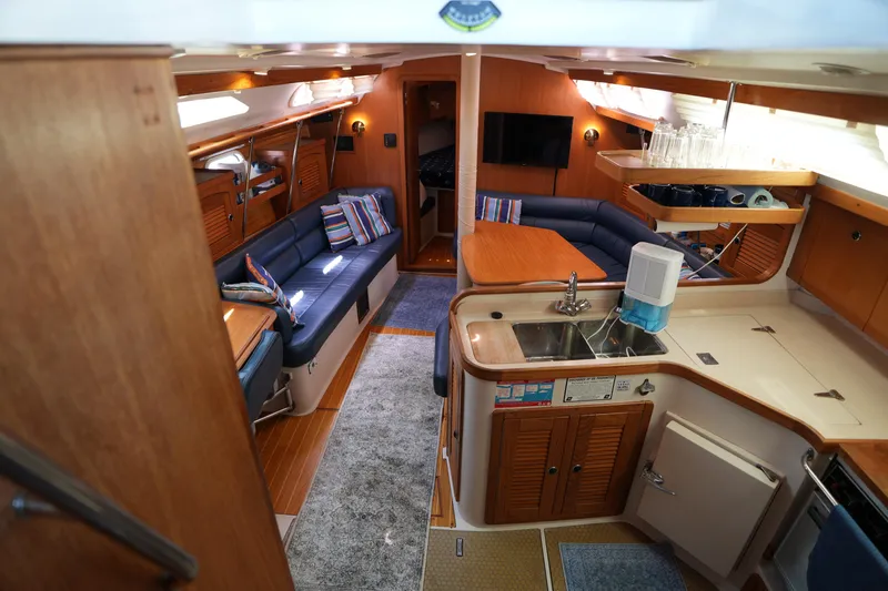 Slide: The Image of Interior of a 2003 Catalina 400 MkII yacht with cozy seating and modern kitchen. - 17