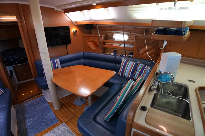 Slide: The Image of Interior of 2003 Catalina 400 MkII yacht with cozy seating and wooden dining table. - 18