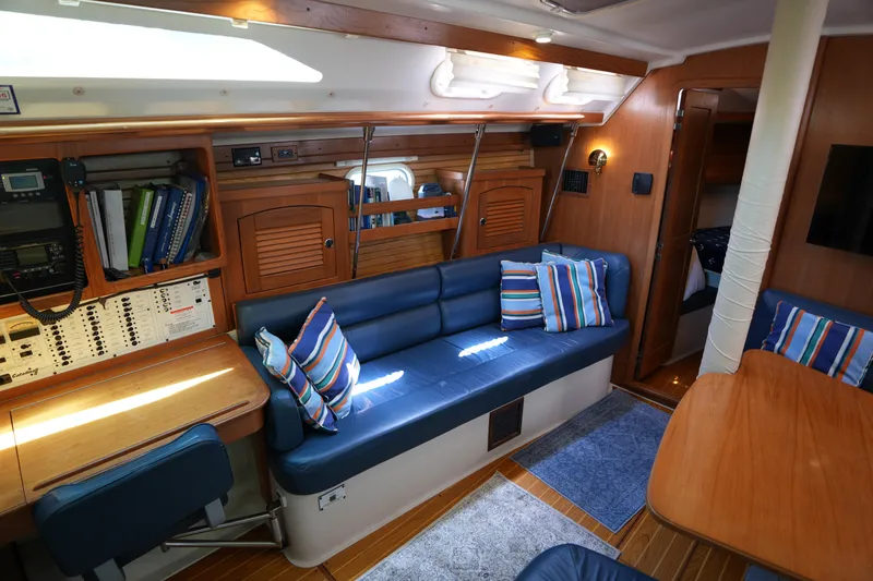 Slide: The Image of Interior of 2003 Catalina 400 MkII yacht with blue seating and striped pillows. - 19