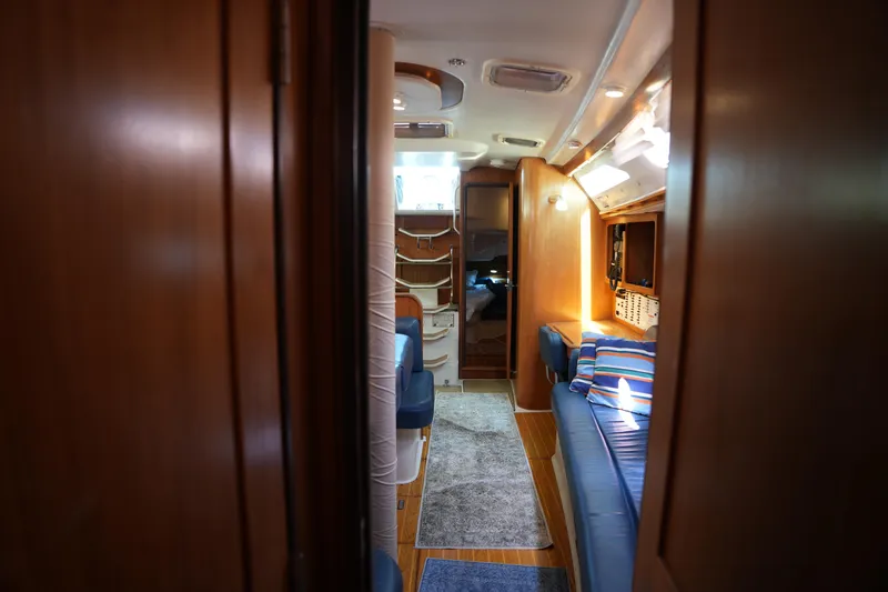 Slide: The Image of Interior of 2003 Catalina 400 MkII sailboat, featuring cozy seating and wooden finishes. - 26
