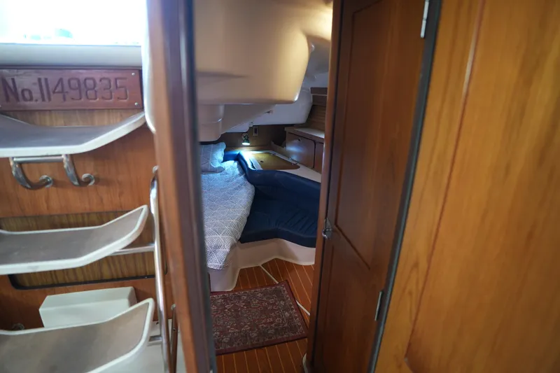 Slide: The Image of Cozy cabin interior of a 2003 Catalina 400 MkII sailboat with wooden finishes. - 27
