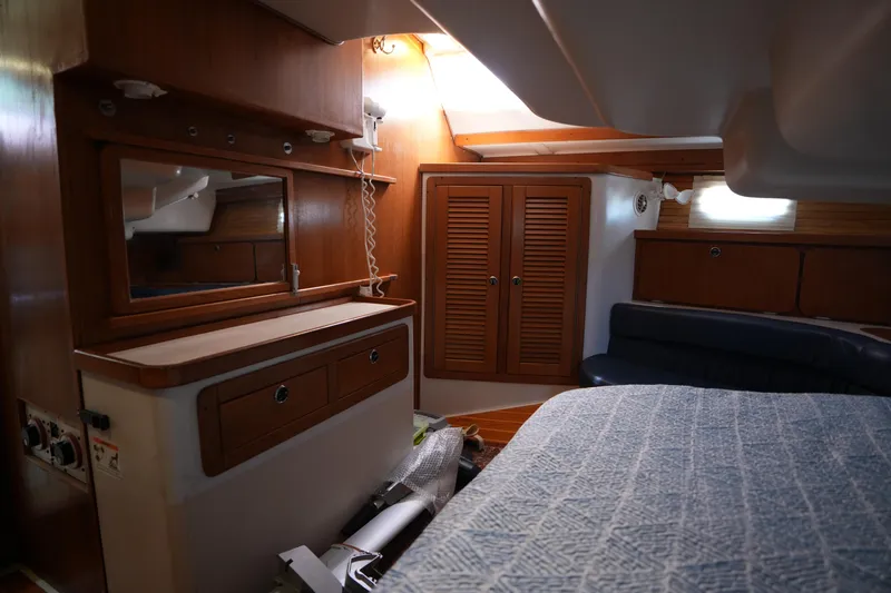 Slide: The Image of Interior of 2003 Catalina 400 MkII sailboat with wooden cabinetry and cozy seating area. - 29
