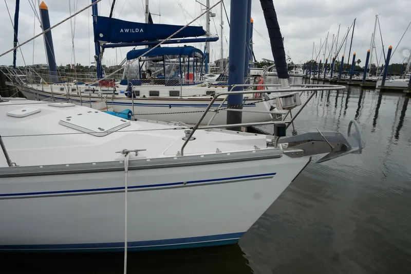 Slide: The Image of 2003 Catalina 400 MkII sailboat docked at a marina on a cloudy day. - 3