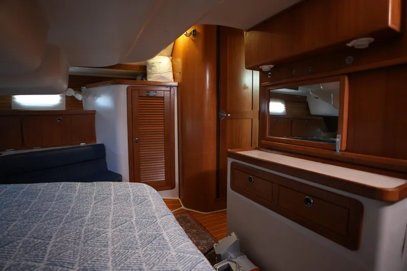 Slide: The Image of Interior of 2003 Catalina 400 MkII yacht with wooden cabinetry and cozy bedding. - 30