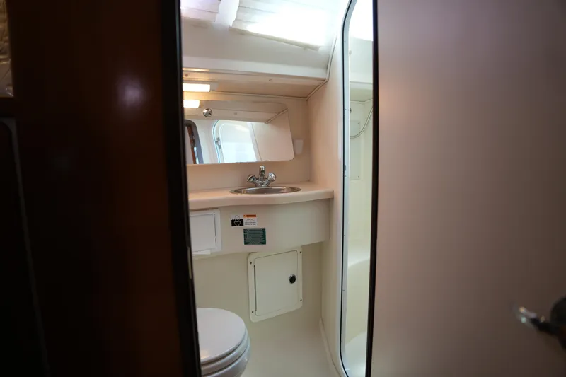 Slide: The Image of Bathroom interior of 2003 Catalina 400 MkII yacht, featuring sink and toilet. - 31