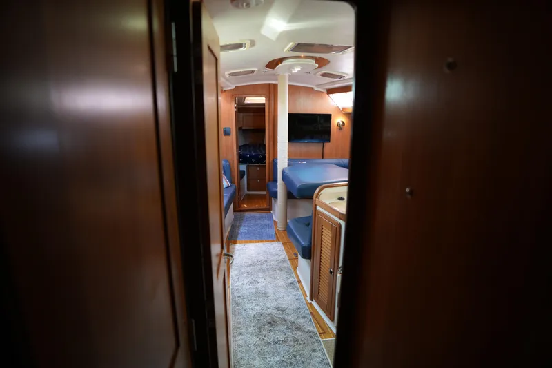 Slide: The Image of Interior view of 2003 Catalina 400 MkII sailboat, featuring cozy seating and wooden finishes. - 33