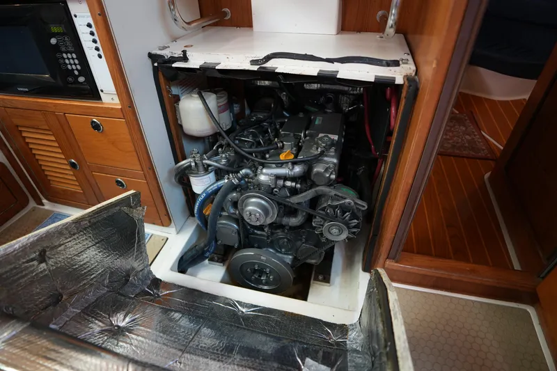 Slide: The Image of Engine compartment of a 2003 Catalina 400 MkII sailboat, showcasing detailed mechanical components. - 34