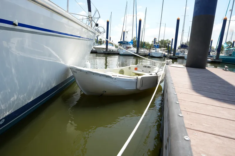 Slide: The Image of Small boat docked beside a Catalina 400 MkII yacht in a marina. - 4