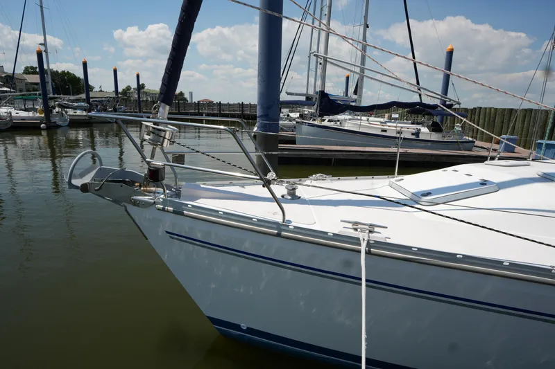 Slide: The Image of Catalina 400 MkII 2003 sailboat docked in a marina under a partly cloudy sky. - 6