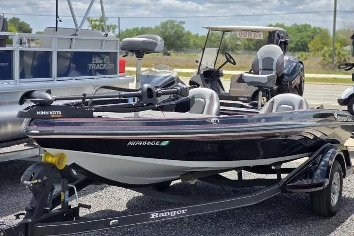 The Image of 2024 Ranger Z518 Cup-Equipped boat with Minn Kota motor on trailer, parked outdoors. - 1