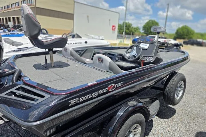 Slide: The Image of 2024 Ranger Z518 Cup-Equipped boat with sleek design and advanced features, parked outdoors. - 12