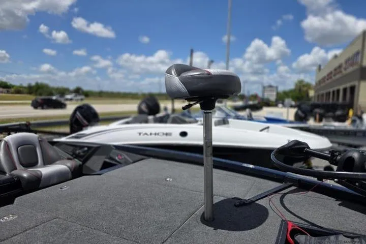 Slide: The Image of 2024 Ranger Z518 Cup-Equipped boat with pedestal seat, parked outdoors under a blue sky. - 16