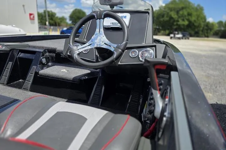 Slide: The Image of 2024 Ranger Z518 Cup-Equipped boat interior with steering wheel and dashboard controls. - 20