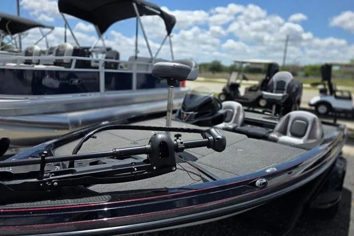 Slide: The Image of 2024 Ranger Z518 Cup-Equipped boat with trolling motor, docked under a sunny sky. - 4